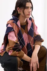 Sweater holgado con diseño de rombos en tonos marrón, negro y rosado, con detalles de lurex en las líneas divisorias. Presenta cuello redondo, mangas largas con puños acanalados y un corte relajado.