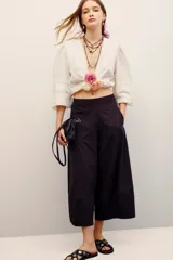 Pantalón babucha color negro, de corte amplio y largo midi, con cintura elástica y bolsillos laterales.