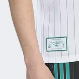 Remera blanca con finas rayas verticales celestes, cuello redondo negro con ribete verde y mangas cortas con ribete negro. Presenta las tres tiras negras características de Adidas en los hombros, el logo de Adidas bordado en el pecho y el escudo del Liverpool FC bordado en el pecho.