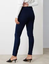 Jean skinny de tiro alto, color azul oscuro, con pretina con pasadores, botón y cierre. Delantera con tres bolsillos, dos simulados y uno aplicado. Trasera con bolsillos aplicados.