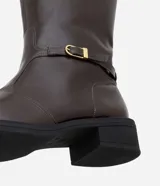 Bota de montar de caña alta confeccionada en poliuretano, con suela robusta, punta redondeada y detalle de hebilla metálica lateral. Cuenta con cierre lateral para mayor practicidad.