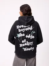 Canguro oversize color negro con efecto lavado, capucha y estampa gráfica en la espalda con tipografía desgastada y detalles en color turquesa.