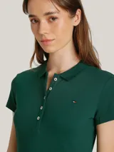 Vestido verde de piqué de algodón orgánico elástico, corte slim, cuello tipo chomba, cartera de 5 botones y logo de Tommy Hilfiger bordado en el pecho.