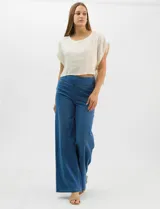 Jegging de tiro alto con silueta estilo palazzo y pierna amplia. Confeccionado en tejido denim con pretina ancha elástica, sin cierre frontal. Presenta diseño frontal liso sin bolsillos y dos bolsillos traseros tipo parche.