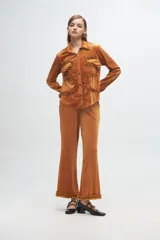 Pantalón de terciopelo color mostaza con textura acanalada, corte recto y detalle de volados en el ruedo.