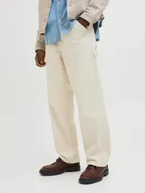 Pantalón jean color crema, corte amplio, con tiro alto, cinco bolsillos y cierre con botones.