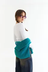 Top de manga larga color amarillo, confeccionado en tejido acanalado con cierre frontal de botones a presión metálicos. Presenta detalles de botones en los puños y un corte ajustado al cuerpo.