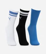 Kit de tres pares de medias deportivas Puma de caña larga. Un par es beige con dos rayas marrones y logo de Puma. Otro par es blanco liso. El tercer par es marrón oscuro con dos rayas blancas y logo de Puma. Todas están confeccionadas en algodón.
