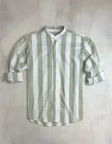 Camisa de hombre a rayas anchas verticales blancas y verde claro, de algodón con apariencia similar al lino. Tiene cuello mao y mangas largas con puños abotonados.