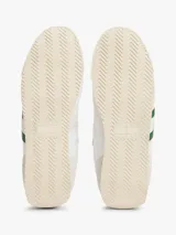 Zapatillas deportivas Tommy Jeans de estilo retro, color blanco con detalles en verde y rosa. Confeccionadas en poliéster con paneles de texturas mixtas, logo de la marca en el lateral y suela de goma.