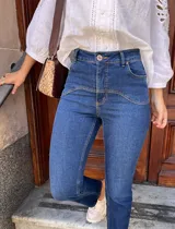 Pantalón de jean azul oscuro, corte recto, tiro alto y detalles de costuras en la parte superior.