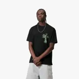 Remera negra de manga corta con calce relajado y cuello redondo ribeteado. Presenta un pequeño estampado gráfico en tono verde claro en el pecho.