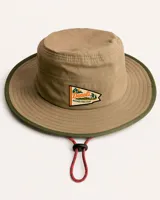 Sombrero tipo pescador color beige con ala ancha, borde reforzado, correa ajustable y parche frontal con el logo de Denali.