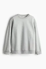 Buzo de tejido de punto color gris melange, con cuello redondo, hombros caídos y puños y bajo acanalados.