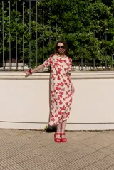 Vestido midi de manga corta, con diseño holgado, cuello redondo y estampado abstracto con detalles florales en tonos marrones y violetas.