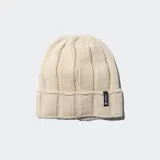 Gorro tipo beanie de tejido acanalado en color crema, con vuelta en el borde y etiqueta de la marca Stance cosida en el lateral.