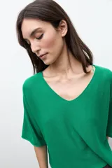Sweater oversized de punto color verde, con escote en V y mangas cortas holgadas.