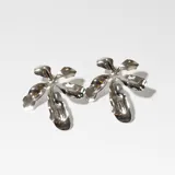 Par de aros colgantes plateados con forma de flor de cinco pétalos.