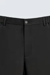 Pantalón de corte relaxed fit, con cintura ajustable, bolsillos delanteros y bolsillo trasero de plastrón. Presenta cierre frontal con cremallera y botón.