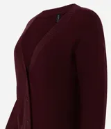 Cardigan de punto color tostado con cuello en V, cierre frontal con botones y mangas largas. Presenta puños y ruedo acanalados.