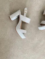 Sandalias de plataforma color marrón, con dos tiras anchas en el empeine y tobillo con hebilla dorada.