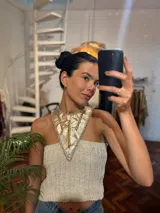 Top tejido en lurex metálico color beige con cuello de cuero con apliques plateados.