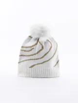 Gorro de lana tejido, color blanco, con diseño de rayas onduladas en hilo dorado y pompón de pelo sintético blanco en la parte superior.