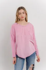Remera manga larga color rosa con bolsillo en el pecho y corte irregular en el ruedo.