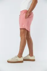 Short de baño liso color salmón, con cintura elástica ajustable mediante cordón, dos bolsillos laterales y un bolsillo posterior.