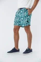 Short de baño azul marino con estampado de hojas de palmera color salmón.