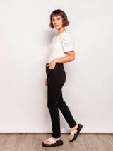 Pantalón chupín negro de tiro alto con bolsillos frontales y traseros.