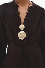 Vestido midi de manga larga en color marrón, con cuello mao abierto, cierre frontal con botones ocultos, puños abotonados y cinturón ajustable para anudar en la cintura.