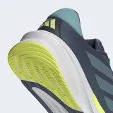 Championes de running Adidas Supernova Stride 2 en color azul marino con detalles en celeste y verde neón. Presentan un exterior de malla textil y sintética para mayor transpirabilidad, mediasuela Dreamstrike+ que ofrece una amortiguación dinámica y suela Adiwear para un agarre duradero.