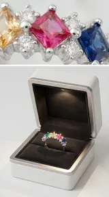 Anillo de plata 925 tipo medio sin fin, con diseño de circonias cuadradas y redondas en diversos colores engastadas en una estructura de plata.