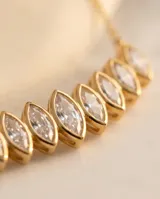 Collar de acero con baño de oro, con diseño en V compuesto por pequeñas circonias engarzadas en forma de marquise.