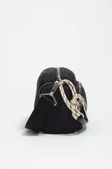 Bolso bandolera mediano de nylon negro con estructura blanda, detalles en piel, asa de hombro combinada de piel y cordón decorativo blanco y negro, cierre de cremallera y logo metálico de la marca.