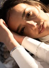 Pulsera de acero quirúrgico color plateado con eslabones rolo y cierre de gancho.