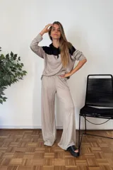 Pantalón de tejido jersey color beige oscuro, de corte muy amplio y pierna ancha, con cintura elástica.