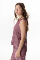 Top sin mangas de corte recto y holgado, confeccionado en tejido de lino con textura jaspeada en tono azul. Presenta cuello redondo y un diseño minimalista ideal para climas cálidos.