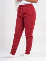 Pantalón babucha deportivo unisex azul, de tiro alto, con puños y cordones ajustables.