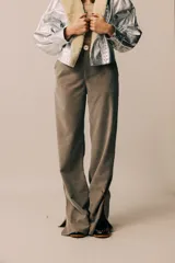 Pantalón de vestir color topo, de tela agamuzada, corte recto y con aberturas en el ruedo.