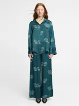 Pantalón palazzo negro con estampado de tigres rosas, cintura elástica y bolsillos laterales.