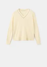 Jersey de punto fino color amarillo claro, con escote en V y manga larga.
