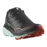 Championes de trail running Salomon Thundercross, color negro con suela verde menta y detalles en naranja. Cuentan con tacos agresivos de 5 mm, amortiguación dinámica y sistema de ajuste preciso.