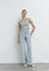 Jean wide leg de tiro bajo, color celeste, con apliques de brillos sutiles en toda la prenda.