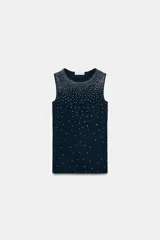 Top sin mangas, color azul marino, con cuello redondo y aplicación de brillos plateados que se dispersan desde el escote hacia el cuerpo.