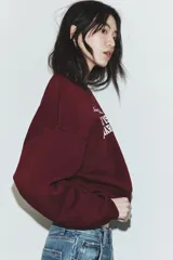 Sudadera de cuello redondo y manga larga, color bordó, con estampado frontal en blanco que dice "Chasing The Sunset's Glow SAN DIEGO 1980 PACIFIC HARBOR".