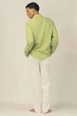 Camisa de manga larga color verde claro, confeccionada en tejido de lino y viscosa, con botones de madera y parche con logo.