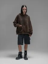Hoodie oversize de algodón con efecto desgastado y oxidado. Presenta costuras expuestas, detalles de roturas en los bordes, capucha y bolsillo frontal tipo canguro.