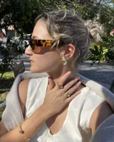 Anillo abierto de diseño minimalista y orgánico, realizado en metal macizo con extremos redondeados de diferentes tamaños.